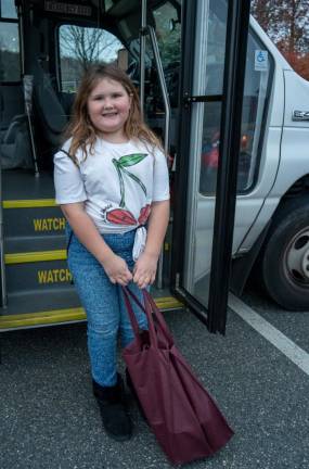 ST3 Riley Dunn donates food to the Stuff the Bus campaign.