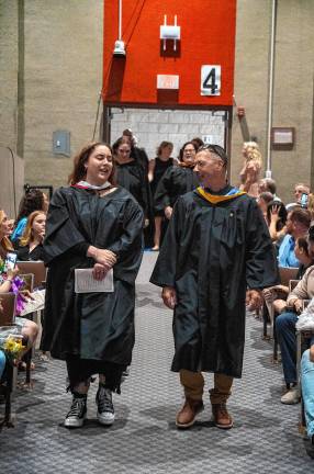 Faculty members walk into the ceremony.