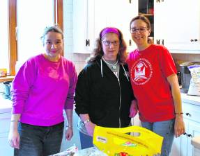 <b>Leeza Kaur of Pass It Along, Rebecca of Rebecca's Homestead and Theresa Senfelice cook for the volunteers.</b>