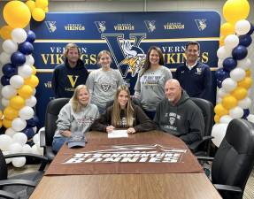 Vernon Township High School senior Sidney Van Tassel, center, agrees to play lacrosse at St. Bonaventure next year. Seated with her are her parents, Michelle and Mark. Standing, from left, are Steve Carlson, head lacrosse coach; Sidney’s sister, Carlie; Casey Jacoby, assistant lacrosse coach; and Kieran Killeen, head field hockey coach. (Photo provided)
