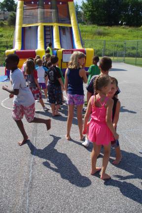 The kids lined up for the PAL inflatable slide that was set up for the day.