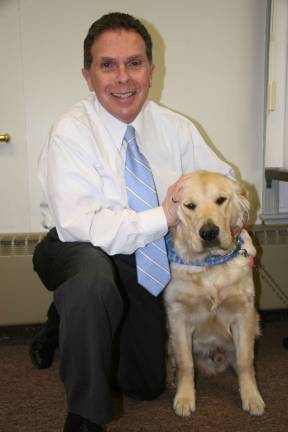 Straus News File Photo Anthony Macerino in 2009 with a seeing-eye dog he trained.