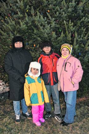 <b>Ed, Jackie, Joshua and Sonia Rios are shown in front of the tree.</b>