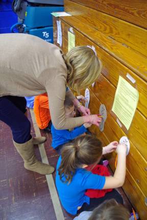 Jaime Gabriele, a parent volunteer from the Walnut Ridge School and Community Association helps teach hands-on skills about the shoe tying process via an exercise called &#x201c;Don&#x2019;t Lose Your Shoes.&#x201d; You start with a &#x201c;loop swoop pull&#x201d; and then make &#x201c;bunny ears.&#x201d;