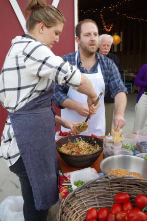 New York City chefs and culinary instructors Clare Langan and Joel Gamoran prepare appetizers for visitors at the Meadowburn Farm Autumn Harvest Dinner.