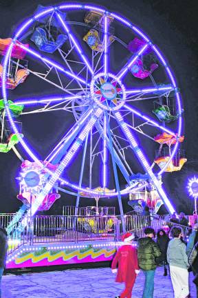 <b>A ferris wheel is lit up.</b>