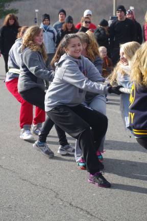 Teams pull trucks for troops