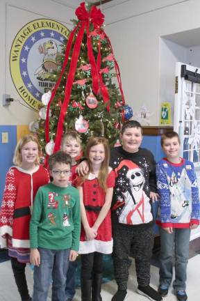 Wantage School students pose in front of a Christmas tree.