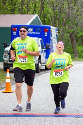 Sean and Peggy Askew of Franklin cross the finish line in Maple Grove Park.