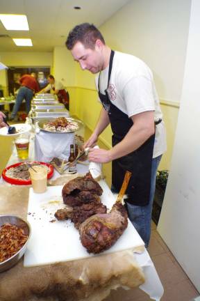 Ptl. Ken Kuzicki slices some venison just before the main meal was served.