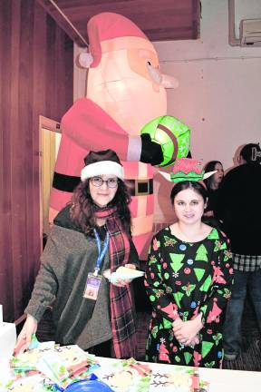<b>Michelle Tagliabue and Katie Healy of Wantage stand in front of a Santa inflatable.</b>