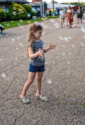 <b>Emma Celone plays with bubbles.</b>