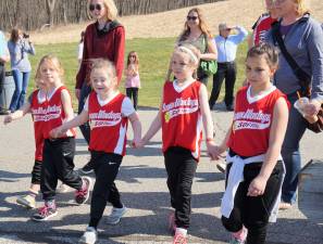 PHOTOS BY JANET REDYKEA Sussex Wantage softball team parades toward the Doherty Memorial Baseball Field.