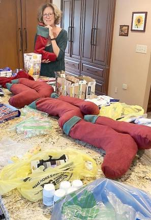 Debra Piccirillo stuffs beautiful handmade Christmas stockings with donated snacks and personal care items (Photo provided)
