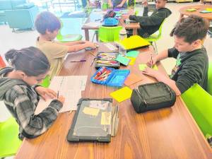 Students at Lounsberry Hollow School in Vernon create Literacy Packets to help young children learn to read. (Photos provided)