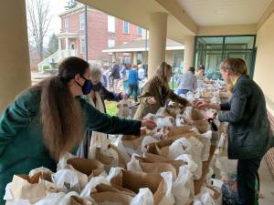 Volunteers and staff will pack Thanksgiving dinners for hundreds of local families at Project Self-Sufficiency.