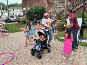 Raj Trivedi, right, hands out free ice pops and ice cream sandwiches to those attending the Ice Cream Social &amp; Jam at Deckertown Commons in Sussex. (Photos by Daniele Sciuto)