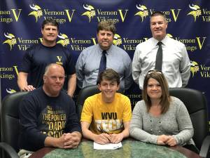 Seated, from left, Father Pete, Morgan and Mother Lynelle; standing, from left, Assistant Coach Brian McCarthy, AD Bill Foley and Head Coach Jim Saganiec.