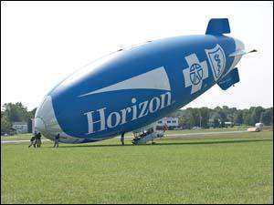 Blimp crewman helps raise ship
