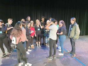 Devin Ilaw (center) visits with Vernon Township High School thespians.