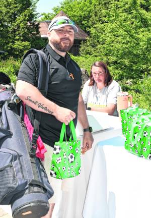 <b>Joe Muscarnero of Vernon holds a soccer bag.</b>