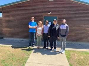 Director of Recreation, Mishelle Downtain with Pastor Edgir jean and members of the Men’s Ministry in front of the snackbar facility at Maple Grange Park.