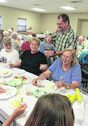 <b>Pastor Barry Young helps serve.</b>