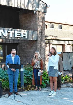 <b>Juliet Gilbert sings the National Anthem during the ceremony.</b>