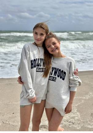 Harper Schmid, left, and Paige Parlapiano pose on the beach in Florida.