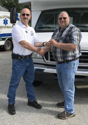 SCARC Senior Transportation Coordinator Barry Woodruff hands the keys to the minibus to Blue Ridge Captain Crag Farry.