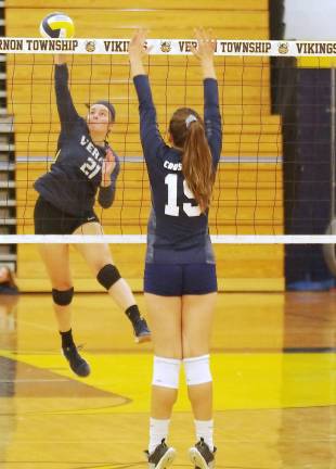 Vernon's Liv Vizzini (21) hits the ball towards the other side of the net. Vizzini made 18 assists.