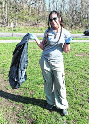 <b>Meg Wahnon of Vernon holds a garbage bag. </b>
