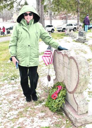 <b>Paula Kuzicki poses after placing a wreath in honor of James Rannazzisi, who served in the Korean War.</b>