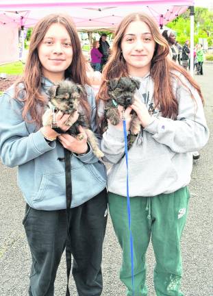 <b>Rhyleigh and Mya Newarski of Sussex pose with their dogs.</b>