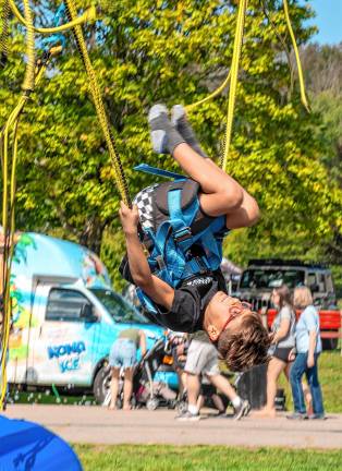 <b>Clay Sucamela turns upside-down on the swing.</b>