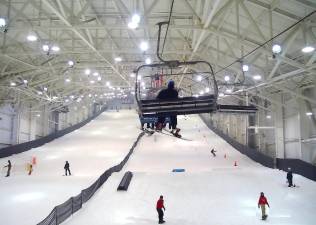 The chair lift at Big SNOW takes skiers and riders to the top of the indoor ski slope.