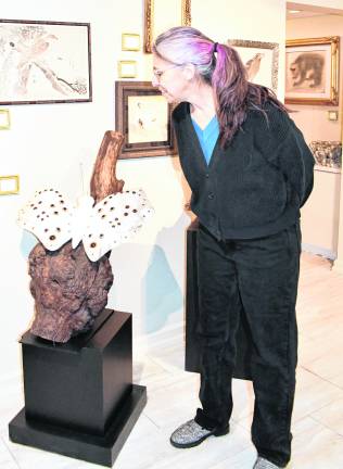 <b>Katy Repka of Denville looks at a piece of art.</b>