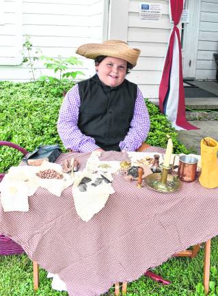<b>Heath Ziccardi shows what soldiers ate during the Revolutionary War.</b>