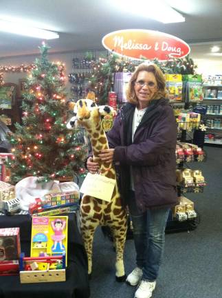 Linda Babcock from Sussex was the winner of a 4-foot tall Melissa &amp; Doug stuffed giraffe.&#xa0; Lakeland Pools &amp; Spas drew the winning ticket on Small Business Saturday, Nov. 30. The Melissa &amp; Doug toy line is new to Lakeland Pools &amp; Spas this summer.