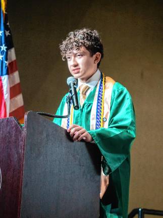 Dylan Castelluccio leads the audience in the Pledge of Allegiance.