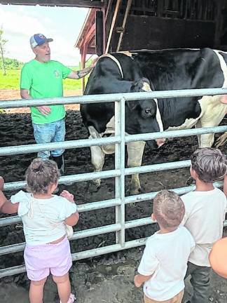 <b>Peter Nussbaum shows a cow to children.</b>