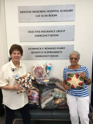 Barbara Wylie, left, of the Newton Medical Center Auxiliary accepts a donation of 40 comfort pillows for hospital patients from Vernon Township Woman’s Club member Reba Burrell. (Photos provided)
