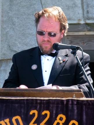 Sussex Elks House Committee and Lodge No. 2288 Treasurer Richard Green reciting the opening prayer for the ceremony