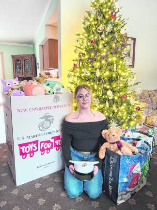 <b>Grace Davenport of Wantage is shown with toys collected in honor of her late brother, Pvt. Ethan Davenport.</b>