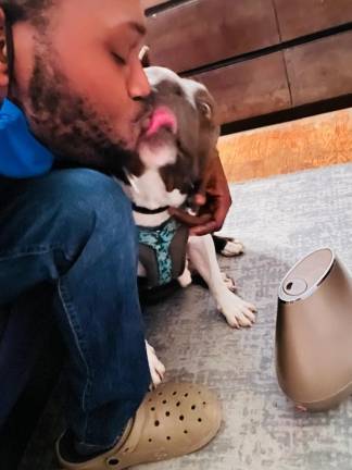 Coqunetay Glenn, who goes by Q, is reunited with his dog, Savage. (Photo provided by Coqunetay Glenn)