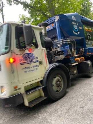 A truck from Blue Diamond Disposal, which took over Ayers’ customers, steams down South Shore Drive in Newton. (Photo by Laurie Gordon)