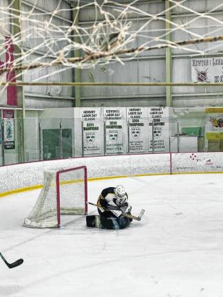 Senior Brady Hendricks celebrates his 1000th save as a goalie for the Vikings ice hockey team during the Feb. 10 game against Clifton at Skylands Ice World in Stockholm. After playing street hockey all his life, he joined the Vernon Township High School team two years ago. (Photo provided)