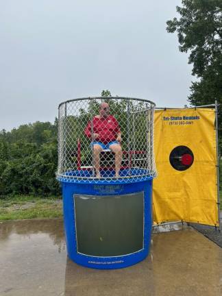 Former Councilman Mike Furrey takes a turn in the dunk tank.