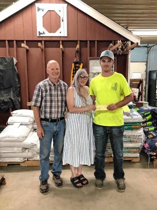 Sussex County Board of Agriculture president Mike Burger and Natalie Burger present Joseph Gigante of Andover with the Gracie’s Scholarship $500 check toward his education. (Photo provided)