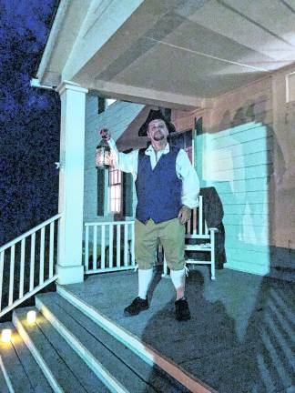 <b>A reenactor holds a lantern.</b>